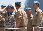 A German navy U.N peacekeeper, left, fixes her beret as she prepares to receive with other comrades the German Defense Minister Ursula von der Leyen, at the UNIFIL German vessel, in the seaport of Beirut, Lebanon, Thursday, April 24, 2014. Leyen is in Lebanon to meet with the Lebanese officials and to visit to the German UNIFIL navy troops. Minister Ursula von der Leyen is in Lebanon to meet with the Lebanese officials and to visit her country’s naval forces. Germany has been a contributor since 2006 to the UNIFIL maritime mission in Lebanon which aims at supporting the Lebanese navy in security Lebanon’s maritime borders. (AP Photo/Hussein Malla)