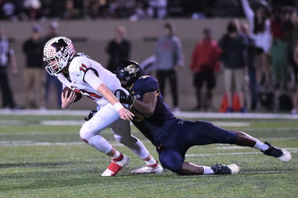 Stephenville's Malachi Arredondo (31) sacks Melissa quarterback Sam Fennegan (11) during Friday's Region II-4A Division I final.