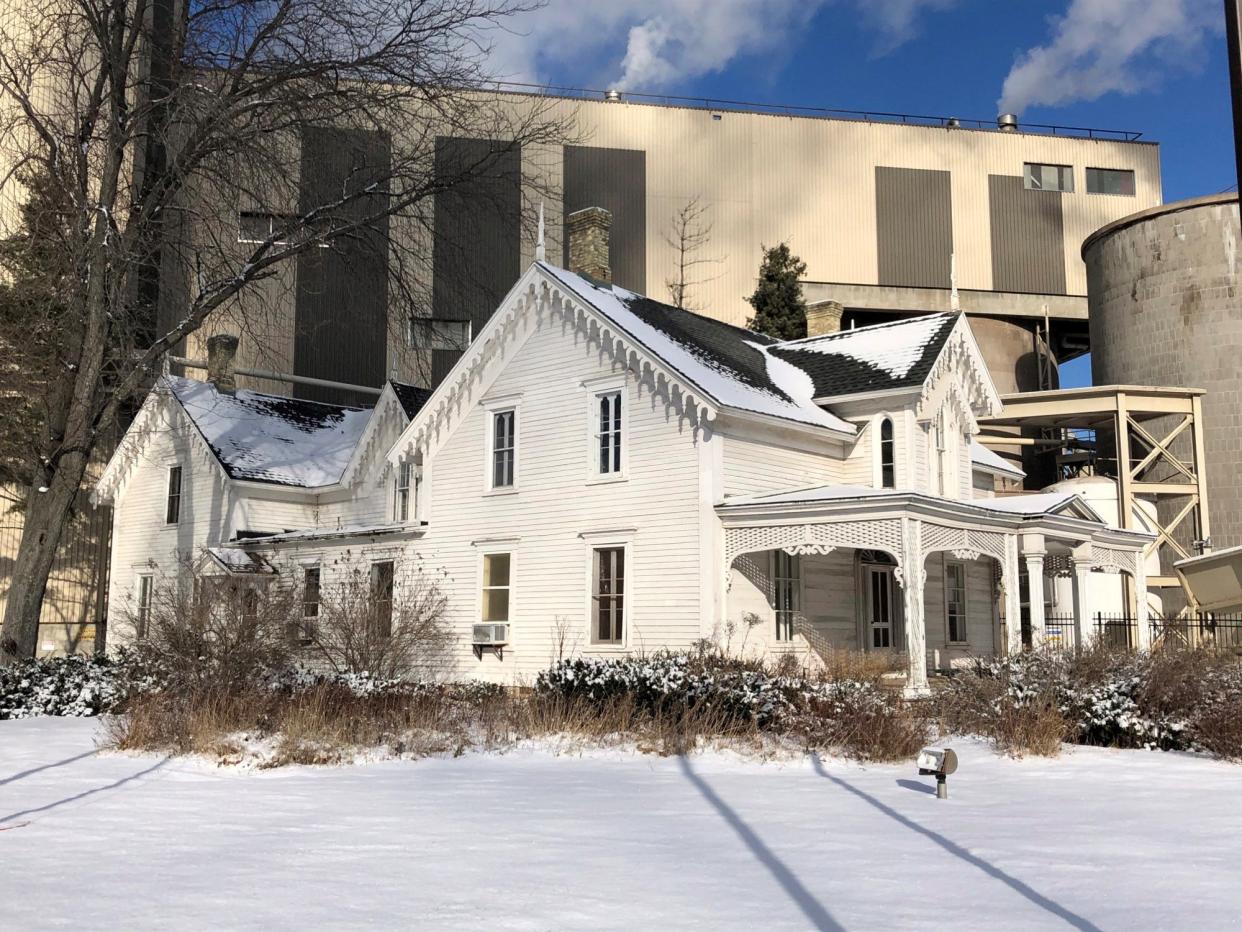 The historic white house sits in the shadow of ND Paper in Biron. Company officials hope a community partner will step forward to take ownership of and move the house.