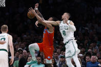 Boston Celtics' Kristaps Porzingis knocks the ball away from Jaylin Williams during the first half of an NBA basketball game Wednesday, April 3, 2024, in Boston. (AP Photo/Winslow Townson)