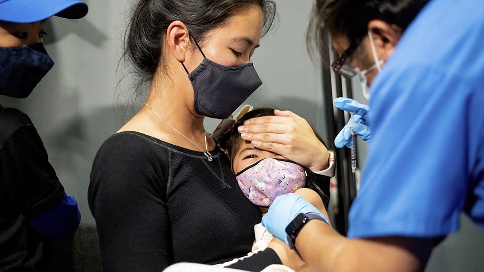 Christina Yep holds daughter Ariel Yep, 5, as she receives a Pfizer-BioNTech COVID-19 vaccine 