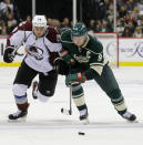 Colorado Avalanche center Ryan O'Reilly (90) and Minnesota Wild center Mikko Koivu (9), of Finland, chase the puck during the second period of Game 4 of an NHL hockey first-round playoff series in St. Paul, Minn., Thursday, April 24, 2014. (AP Photo/Ann Heisenfelt)