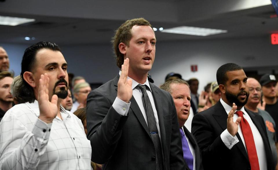 YouTube celebrity Cleetus McFarland, center, whose real name is Garrett Mitchell, and other Myakka City residents showed up to a Manatee Board of County Commissioners meeting to share their stance against a developer’s plan to build 4,500 homes near the DeSoto Speedway, citing future noise complaints and urban sprawl. Tiffany Tompkins/ttompkins@bradenton.com