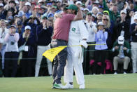 Jon Rahm, of Spain, embraces his caddie Adam Hayes on the 18th hole as Rahm won the final round of the Masters golf tournament at Augusta National Golf Club on Sunday, April 9, 2023, in Augusta, Ga. (AP Photo/Mark Baker)