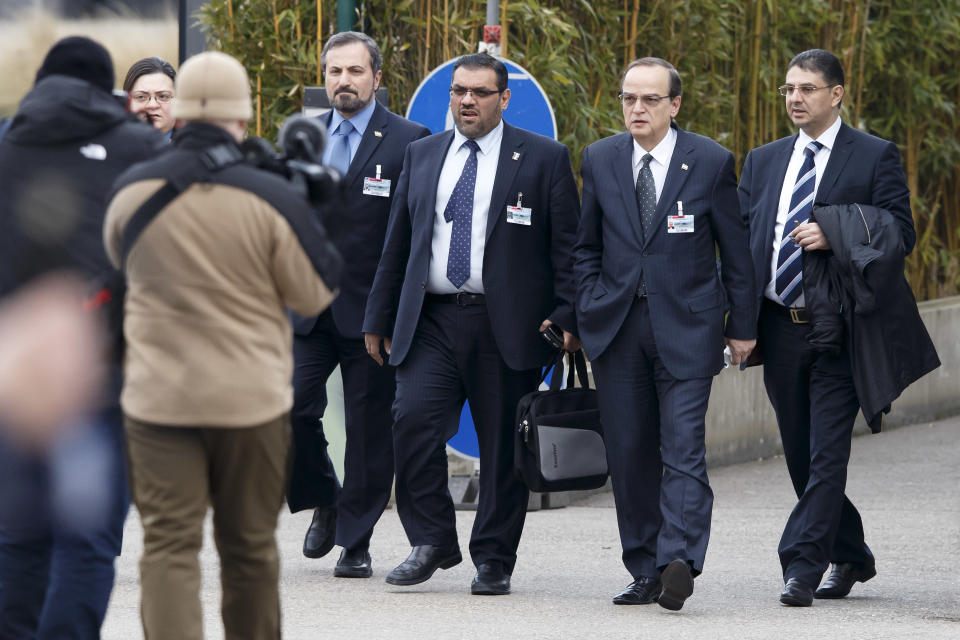 Syrian opposition chief negotiator Hadi Bahra, 2nd right, arrives with Louay Safi, left, spokesman for the Syrian National Coalition and Syria's main political opposition group, and a member of delegation Anas al-Abdeh, 2nd left, for a meeting at the European headquarters of the United Nations, in Geneva, Switzerland, Saturday, Jan. 25, 2014. Two Syrian delegations, representatives of Syrian President Bashar al-Assad and Syrian opposition, are meeting together with the Joint Special Representative.(AP Photo/Keystone,Salvatore Di Nolfi)