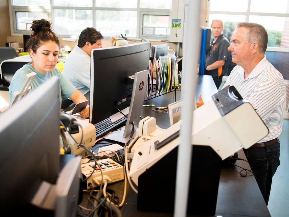 Michelle Prate, left, works with David Kristy, right, as he applies for a Real ID-compliant driver's license at the Strawberry Plains Driver Services Center on Friday, July 5, 2019.