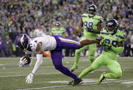 Seattle Seahawks' Justin Coleman, right, brings down Minnesota Vikings' Laquon Treadwell after a pass reception by Treadwell in the second half of an NFL football game, Monday, Dec. 10, 2018, in Seattle. (AP Photo/Ted S. Warren)