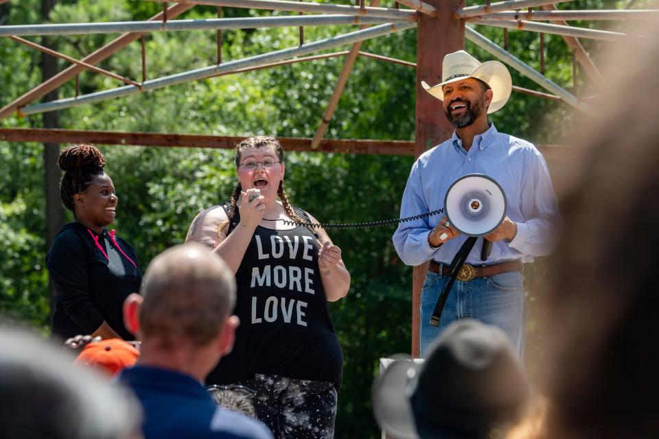 In a Saturday, June 6, 2020 photo, organizers Yalakesen Baaheth, left, Madison Malone and Rev. Michael Cooper of the local NAACP speak to those assembled in Gould Park in Vidor, Texas. Several hundred people came out to the park on Saturday afternoon for a protest and peace march in honor of George Floyd who died while being detained by Minneapolis police.