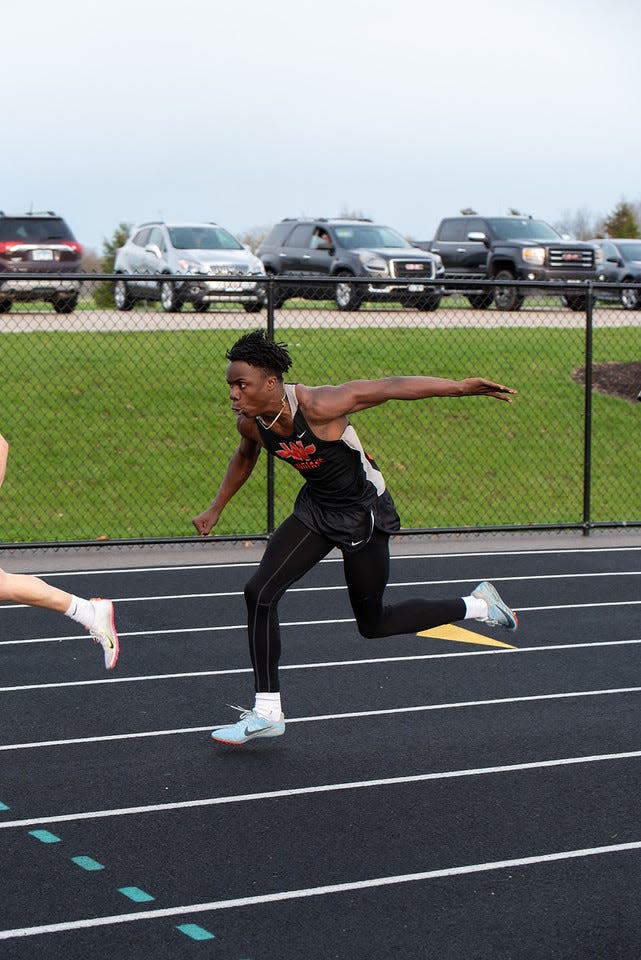 Winnebago sprinter Supreme Muhammad reaches for the baton during one of his team's track meets earlier this month. Muhammad just clocked the state's sxith-fastest time in the 100-meter dash for Class 1A athletes.