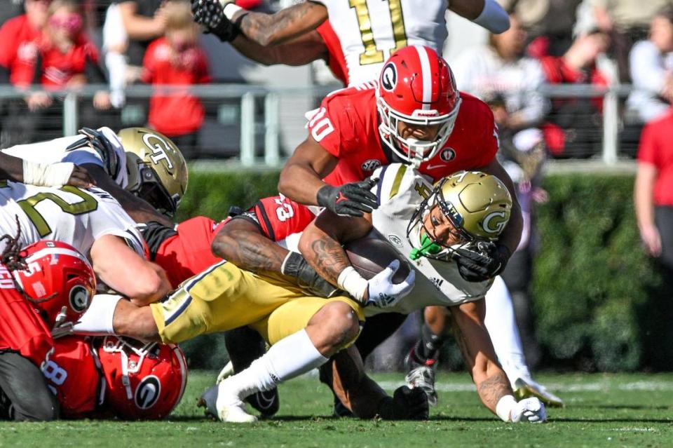 Georgia Tech running bcak Dontae Smith gets tackled at the line of scrimmage by Georgia defender Jamon Dumas-Johnson.