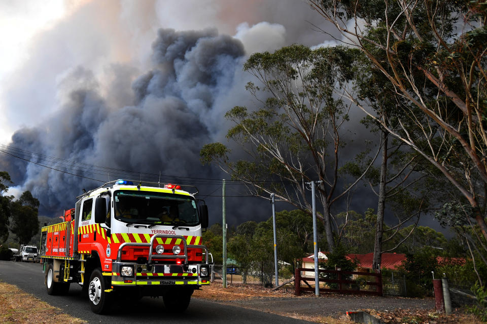 Rural Fire Service crews engage in property protection of a number of homes along the Old Hume Highway near the town of Tahmoor as the Green Wattle Creek Fire threatens a number of communities.