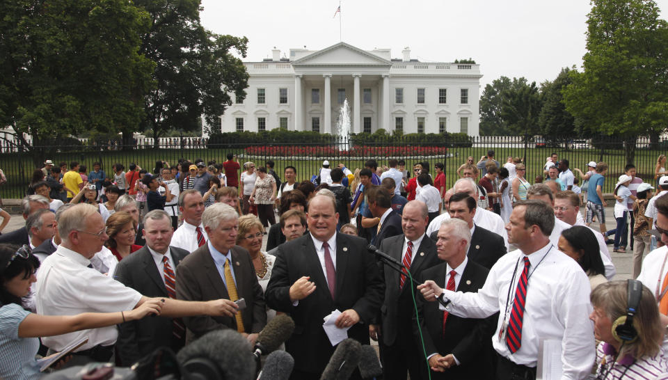 FILE - Rep. Tom Reed, R-N.Y., center, is joined by other members of congress outside the White House in Washington, July 19, 2011, after releasing a letter to President Barack Obama urging him to deal with the debt ceiling crisis. Lessons learned from the debt ceiling standoff more than a decade ago are rippling through Washington. Back in 2011 the debate around raising the debt ceiling was eerily familiar. Newly elected House Republicans were eager to confront the Democratic president and force spending cuts. (AP Photo/Pablo Martinez Monsivais, File)