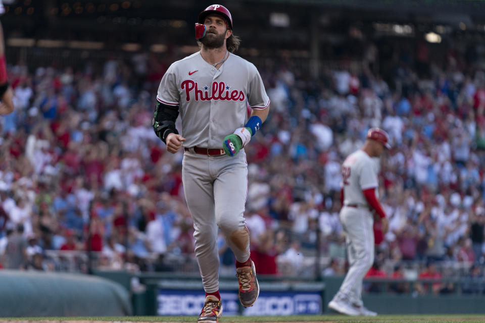 Philadelphia Phillies designated hitter Bryce Harper runs toward home base after Bryson Stott hit a home run during the eighth inning of a baseball game against the Washington Nationals, Saturday, Aug. 19, 2023, in Washington. (AP Photo/Stephanie Scarbrough)