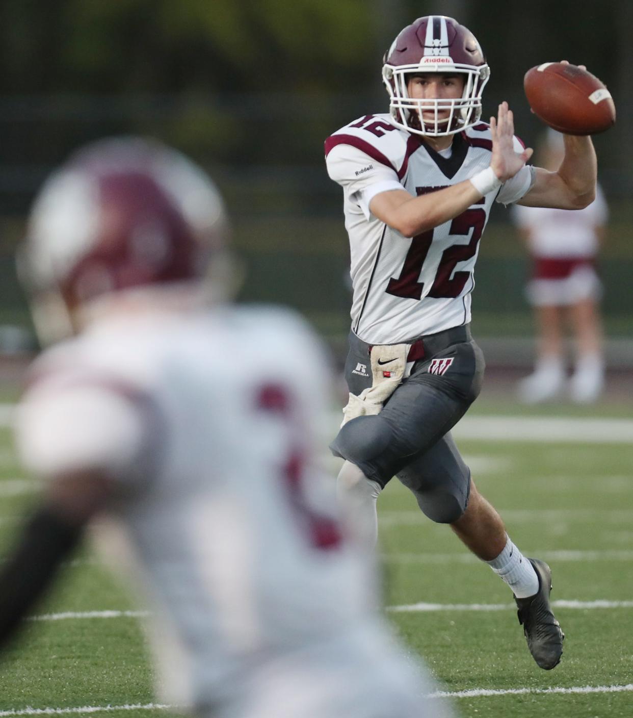 Woodridge quarterback David Hitchings looks to connect with running back Robert Dixie during their game against Norton at Norton High School on Friday, Sept. 17, 2021, in Norton.