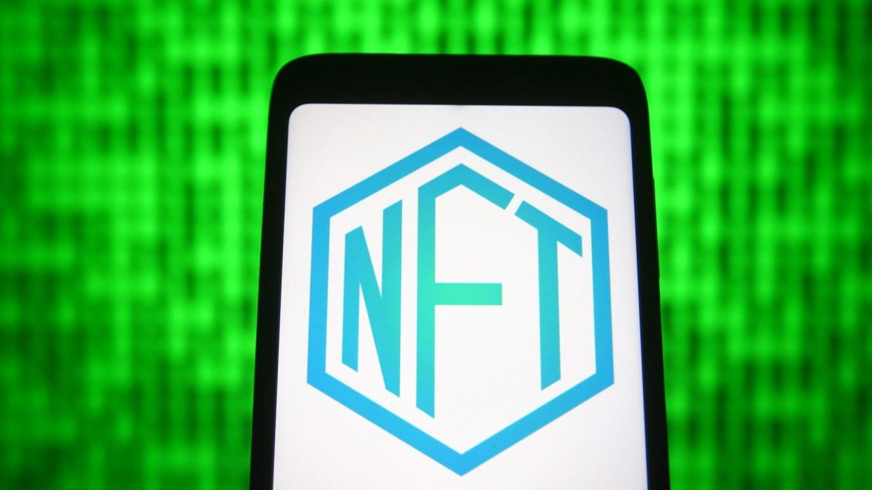 Mandatory Credit: Photo by Pavlo Gonchar/SOPA Images/Shutterstock (11866604s)In this photo illustration a NFT ( Non-fungible token) sign is seen on a smartphone screen.