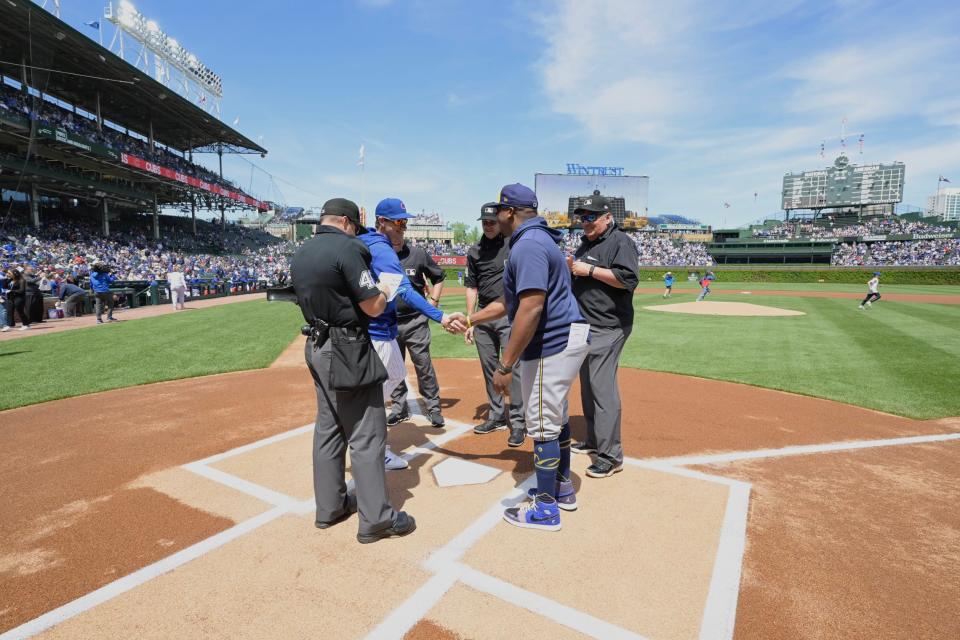 Milwaukee Brewers associate manager exchanges lineup cards with Chicago Cubs manager Craig Counsell before the game on May 3, 2024 at Wrigley Field.