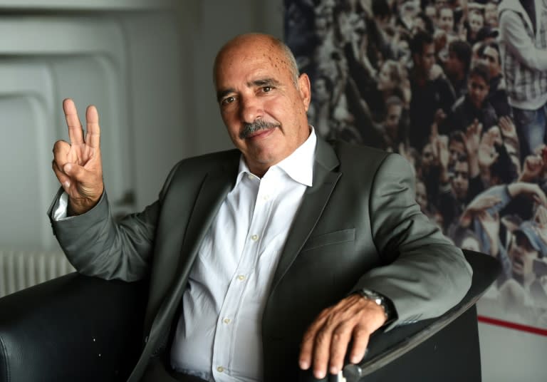 President of the Tunisian Human Rights League, Abdessattar Ben Moussa, flashes the "V" for victory as he poses for pictures in Tunis on October 9, 2015