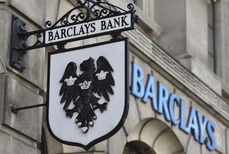 A Barclays sign hangs outside a branch of the bank in the City of London July 30, 2014. REUTERS/Toby Melville