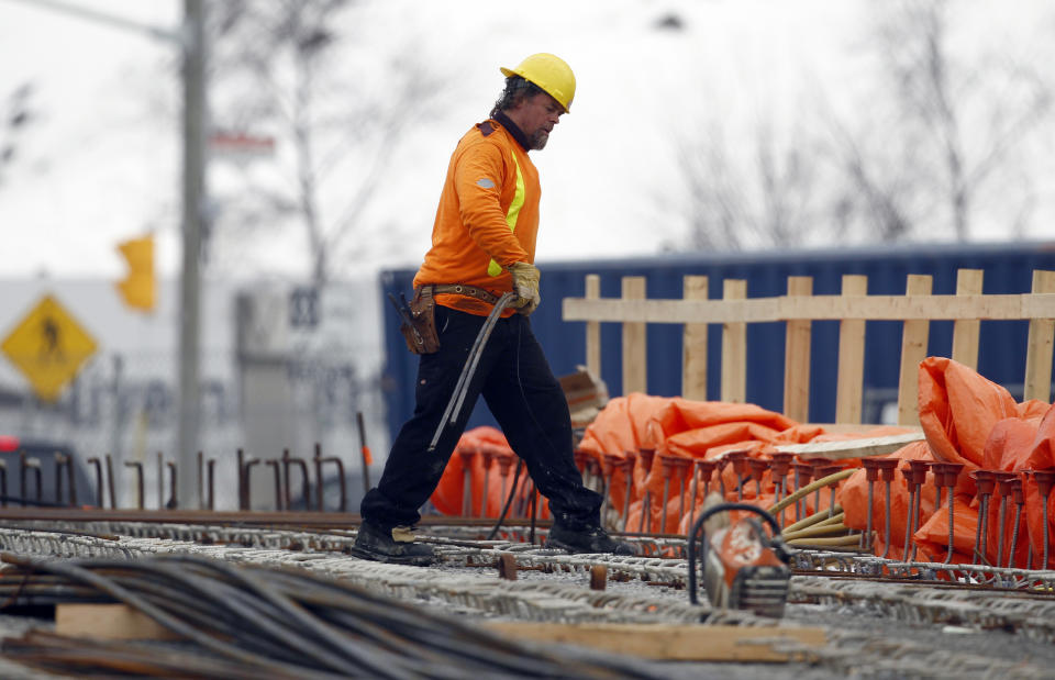 A worker walks at a bridge under construction in Toronto February 20, 2014. Picture taken February 20. REUTERS/Aaron Harris  (CANADA - Tags: BUSINESS CONSTRUCTION REAL ESTATE EMPLOYMENT)