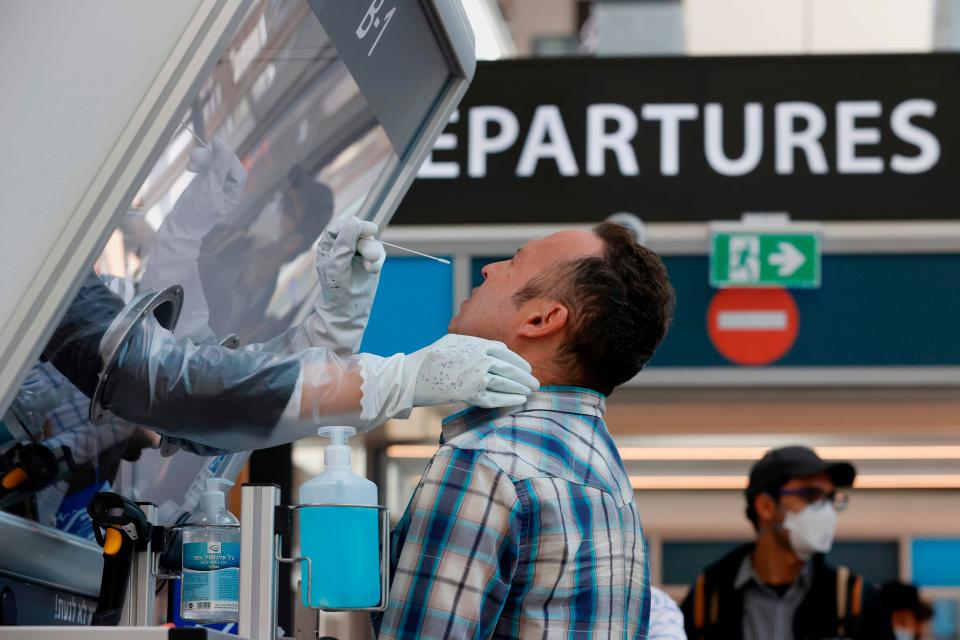 <p>A man is tested for coronavirus at Israel’s Ben Gurion International Airport</p> (AFP via Getty Images)