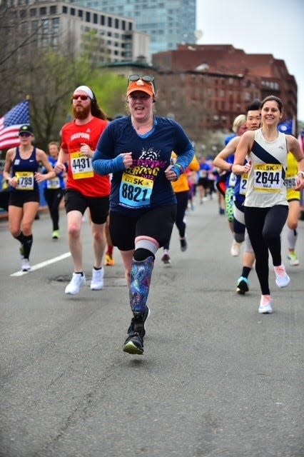 Amy Pietrafitta, of Plymouth, participated in a clinical trial combining innovative surgery with an experimental bionic prosthetic, which she said enables her to run more naturally than with the prosthetic she uses in races like this Boston Athletic Association 5K.