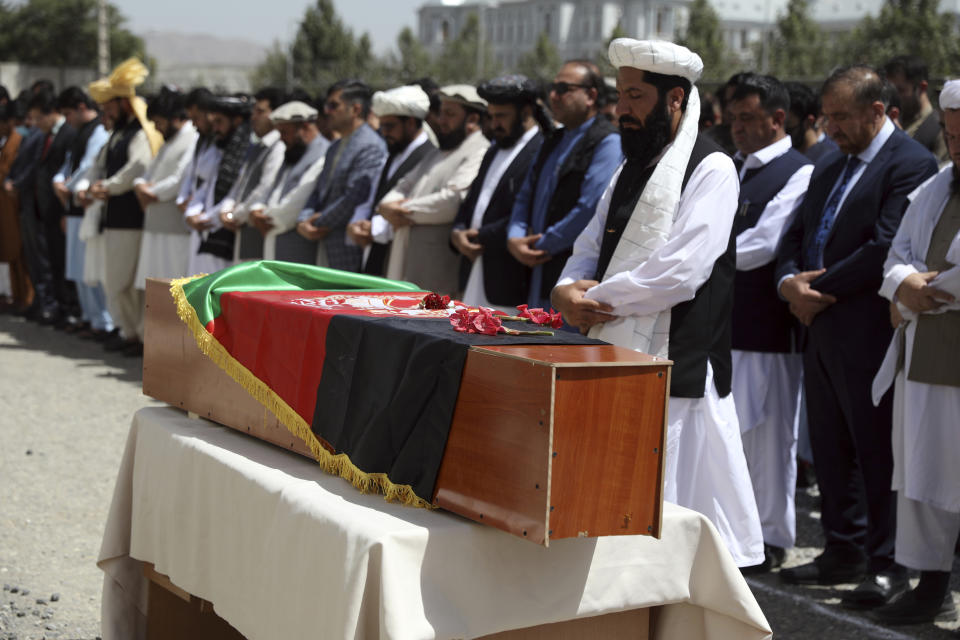 Relatives, colleagues and friends offer funeral prayers behind the body of Dawa Khan Menapal, director of Afghanistan's Government Information Media Center, in Kabul, Afghanistan, Saturday, Aug. 7, 2021. The Taliban ambushed and killed the director of Afghanistan's government media center on Friday in the capital, Kabul, the latest killing of a government official just days after an assassination attempt on the country's acting defense minister. (AP Photo/Rahmat Gul)
