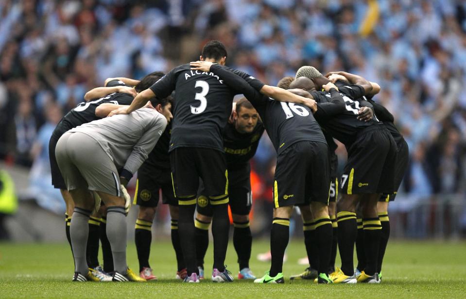 Wigan Athletic players form a huddle prior to kick-off