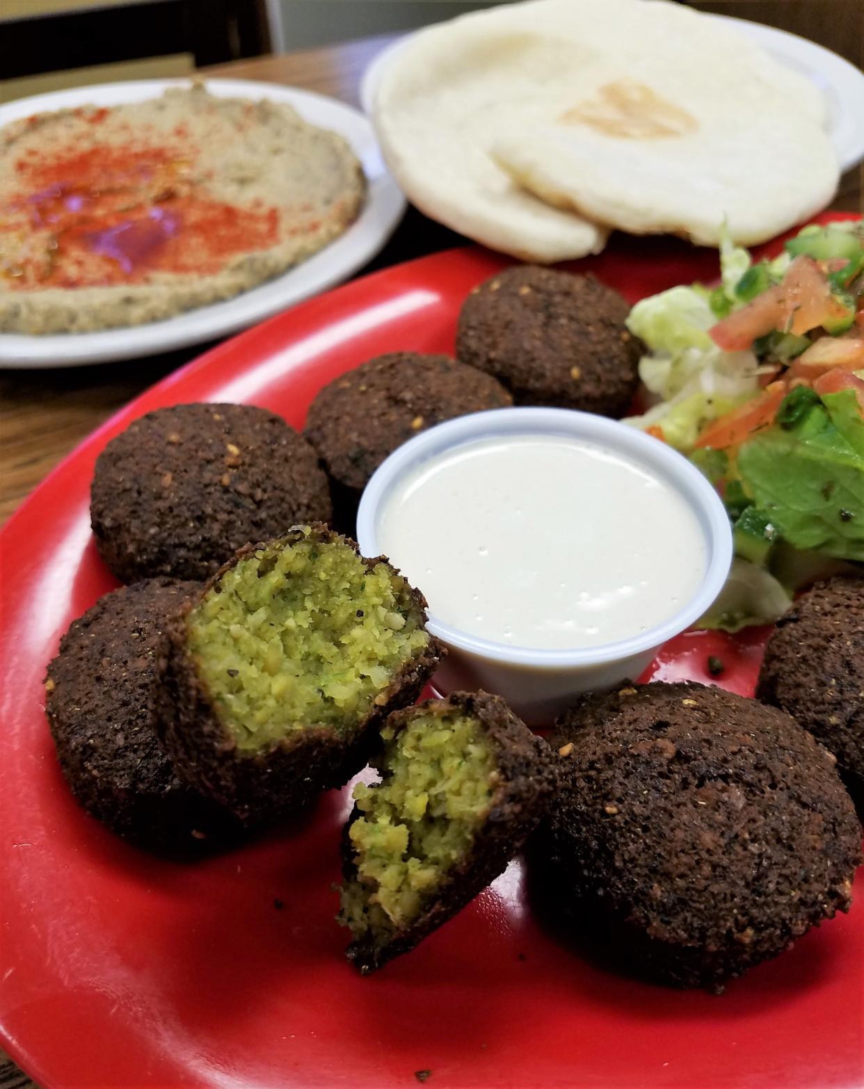 Falafel at Manna Mediterranean Grill are served with tahini sauce, pita bread and a side of your choice. We like the refreshing Mediterranean salad.