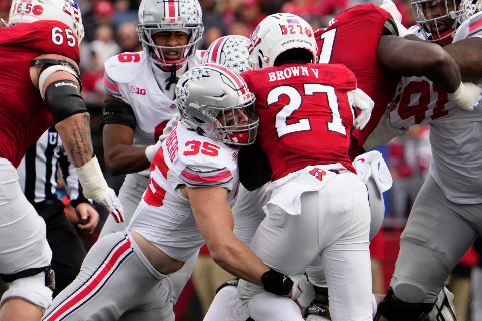Nov 4, 2023; Piscataway, New Jersey, USA; Ohio State Buckeyes linebacker Tommy Eichenberg (35) tackles Rutgers Scarlet Knights running back Samuel Brown V (27) in the backfield during the first half of the NCAA football game at SHI Stadium.