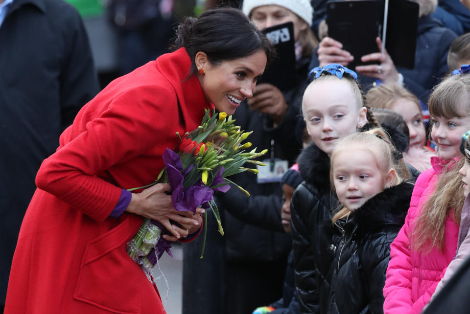 Meghan meets children during a walkabout [Photo: PA]
