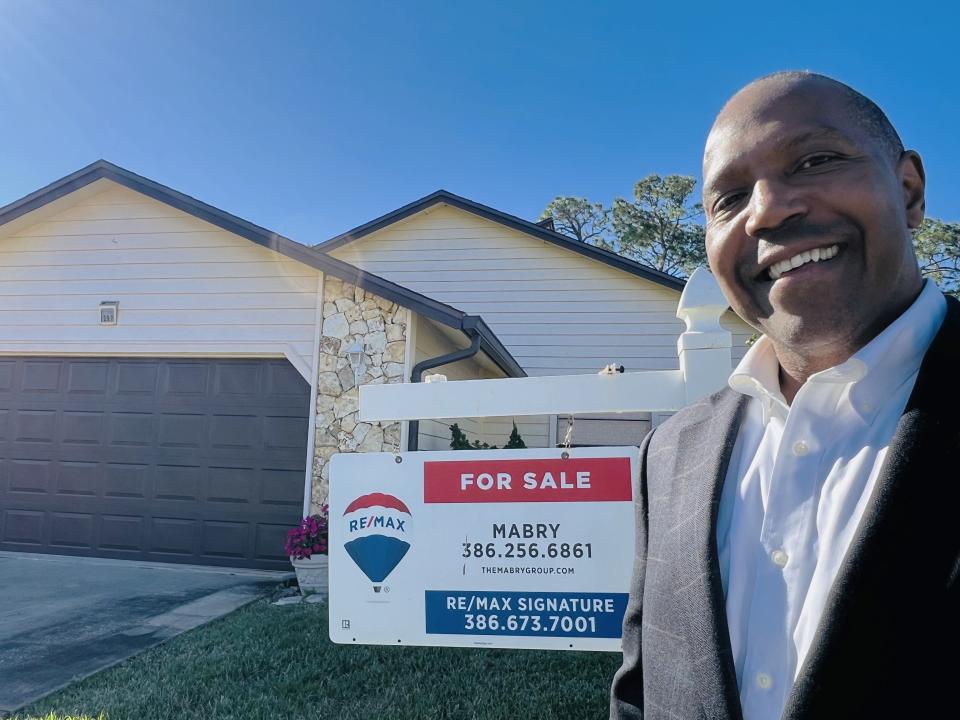 P.W. Mabry, an agent with Re/Max Signature in Ormond Beach and 2024 board president of the Daytona Beach Area Association of Realtors, stands in front of his newest listing, a single-family home in Daytona Beach's Pelican Bay community,"We have more inventory right now and we have buyers that are calling us to see more properties because of the interest rates going down."