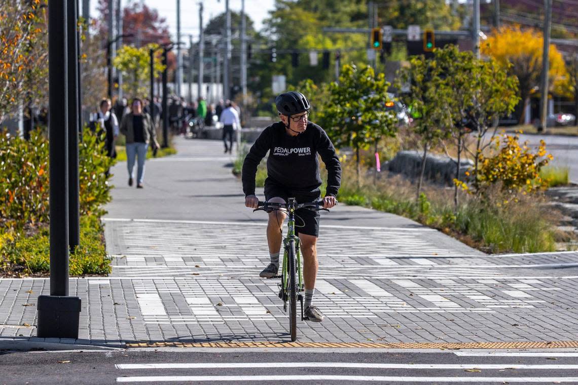 Howard Florence rides his bicycle along the Town Branch Commons trail near Midland Avenue in Lexington, Ky., following a ribbon cutting ceremony Thursday, Oct. 13, 2022, for the completion of the more than two-mile trail through downtown.