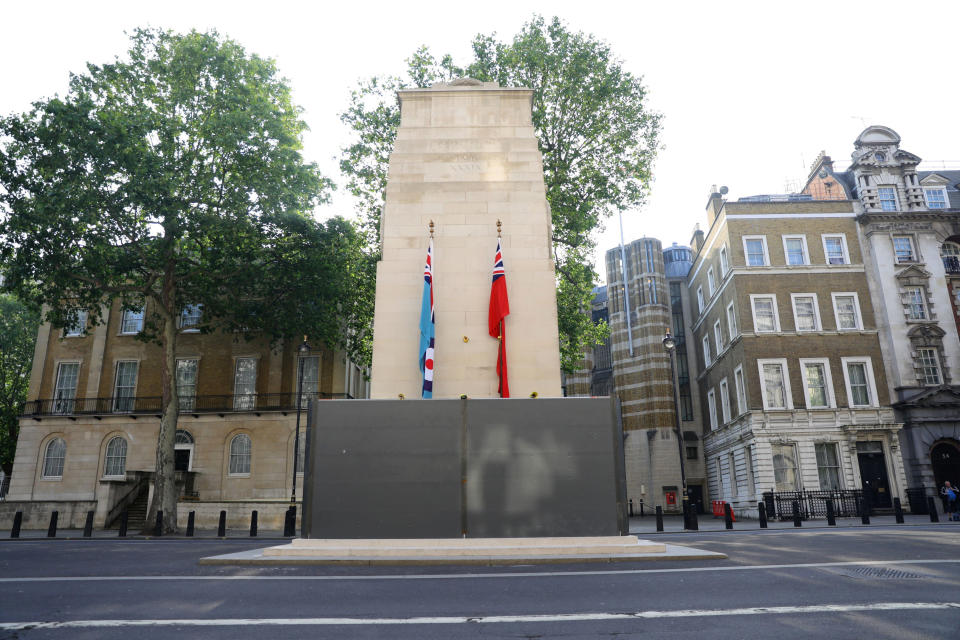 A protective shield installed overnight surrounds the statue of the Cenotaph in Whitehall, London, Friday, June 12, 2020, following Black Lives Matter protests that took place across the UK over the weekend. The protests were ignited by the death of George Floyd, who died after he was restrained by Minneapolis police on May 25. (Aaron Chown/PA via AP)