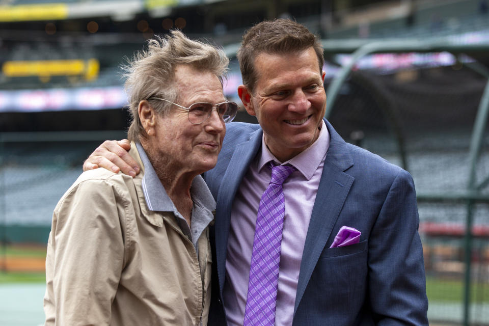 FILE - Los Angeles Angels TV play-by-play announcer Patrick O'Neal, right, poses with his father, actor Ryan O'Neal before a baseball game against the Oakland Athletics in Anaheim, Calif., Saturday, May 21, 2022. O’Neal, who was nominated for an Oscar for the tear-jerker “Love Story” and played opposite his precocious daughter Tatum in “Paper Moon,” has died. O’Neal's son Patrick said on Instagram that his father died Friday, Dec. 8, 2023. (AP Photo/Alex Gallardo, File)