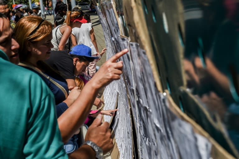 Colombian voters check the electoral rolls at a polling station in Medellin during elections to select a new Congress