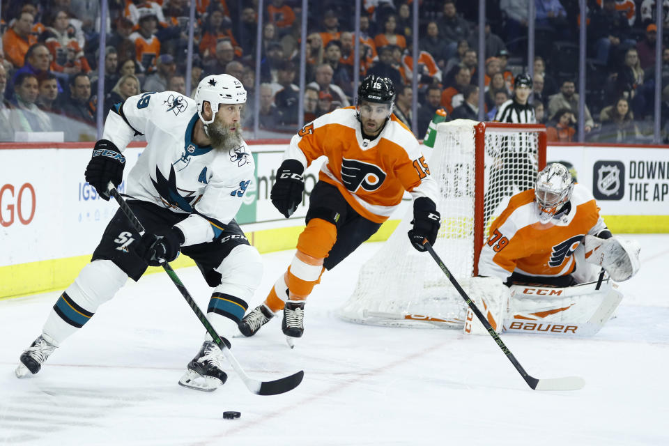 San Jose Sharks' Joe Thornton, left, skates past Philadelphia Flyers' Matt Niskanen, center, and Carter Hart during the first period of an NHL hockey game, Tuesday, Feb. 25, 2020, in Philadelphia. (AP Photo/Matt Slocum)