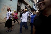 FILE - In this Dec. 12, 2015 file photo, Democratic Unity opposition coalition congressman Miguel Pizarro, center, greets supporters during a rally to thank those that voted for him, at the Petare neighborhood in Caracas, Venezuela. Pizzarro is focused on bread-and-butter issues rather than confrontations in the streets. "The challenge for political leaders is to win back the right to listen to the country," he said. (AP Photo/Fernando Llano, File)