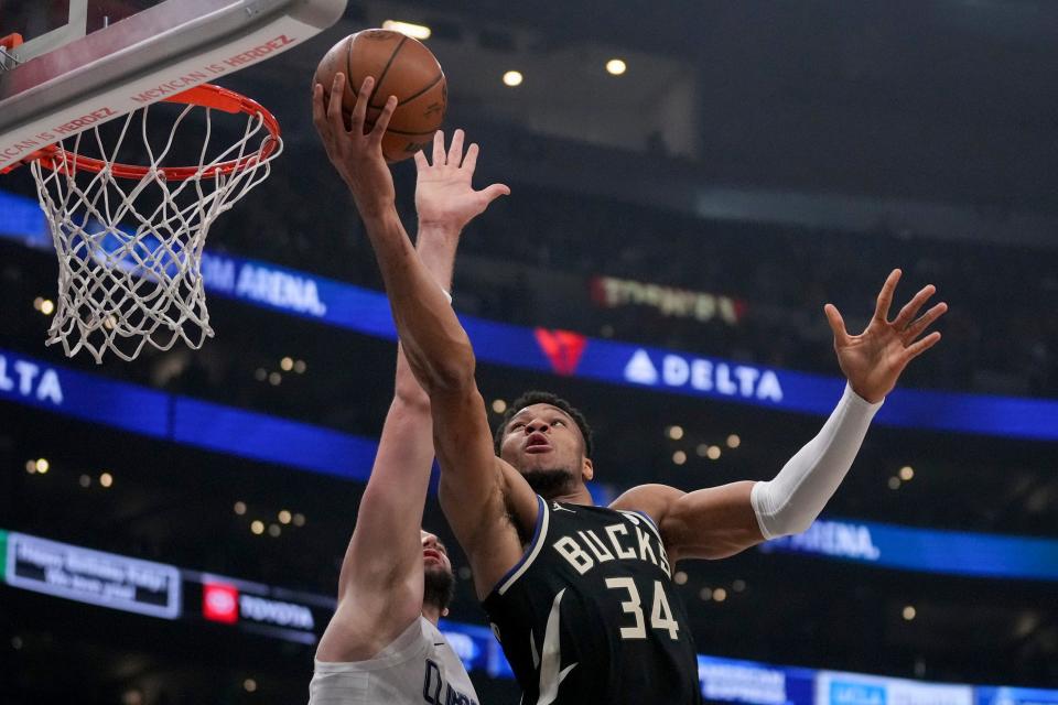 Milwaukee Bucks forward Giannis Antetokounmpo goes to the basket against Los Angeles Clippers center Ivica Zubac during the first half Sunday in Los Angeles.