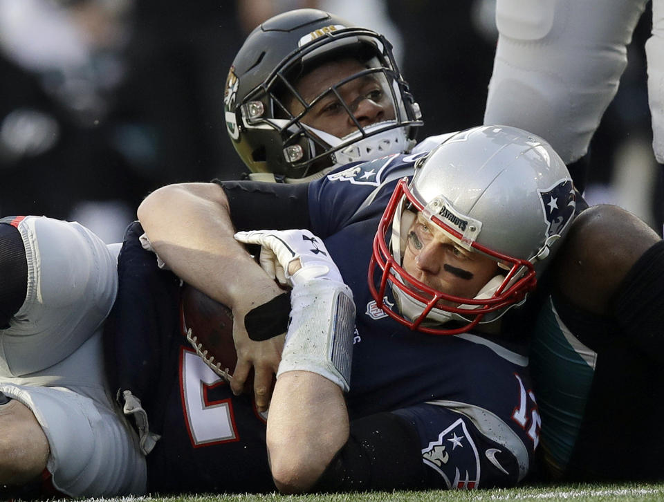 FILE - In this Jan. 21, 2018, file photo, New England Patriots quarterback Tom Brady, front, holds onto the ball as he goes down against Jacksonville Jaguars defensive end Dante Fowler during the first half of the AFC championship NFL football game in Foxborough, Mass. The Jaguars have suspended All-Pro cornerback Jalen Ramsey and Fowler for violating team rules and conduct unbecoming a Jaguars football player. (AP Photo/Charles Krupa, File)