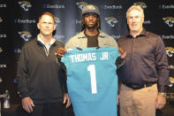 Jacksonville Jaguars first-round draft pick wide receiver Brian Thomas Jr. poses while holding a jersey with general manager Trent Baalke, left, and head coach Doug Pederson, during an NFL football press conference, Friday, April 26, 2024, in Jacksonville, Fla. (AP Photo/Gary McCullough)