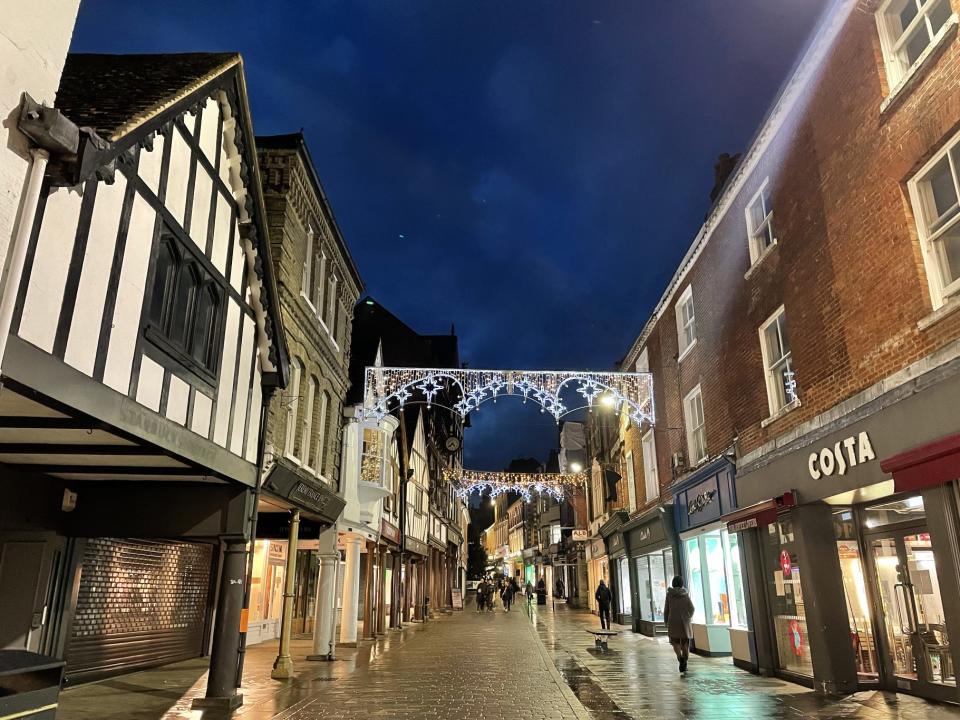 Shops along a historic street in Winchester, UK.