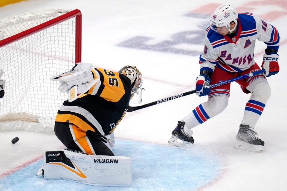 New York Rangers' Artemi Panarin (10) backhands a shot past Pittsburgh Penguins goaltender Tristan Jarry (35) for a goal during the first period of an NHL hockey game in Pittsburgh, Saturday, March 16, 2024.