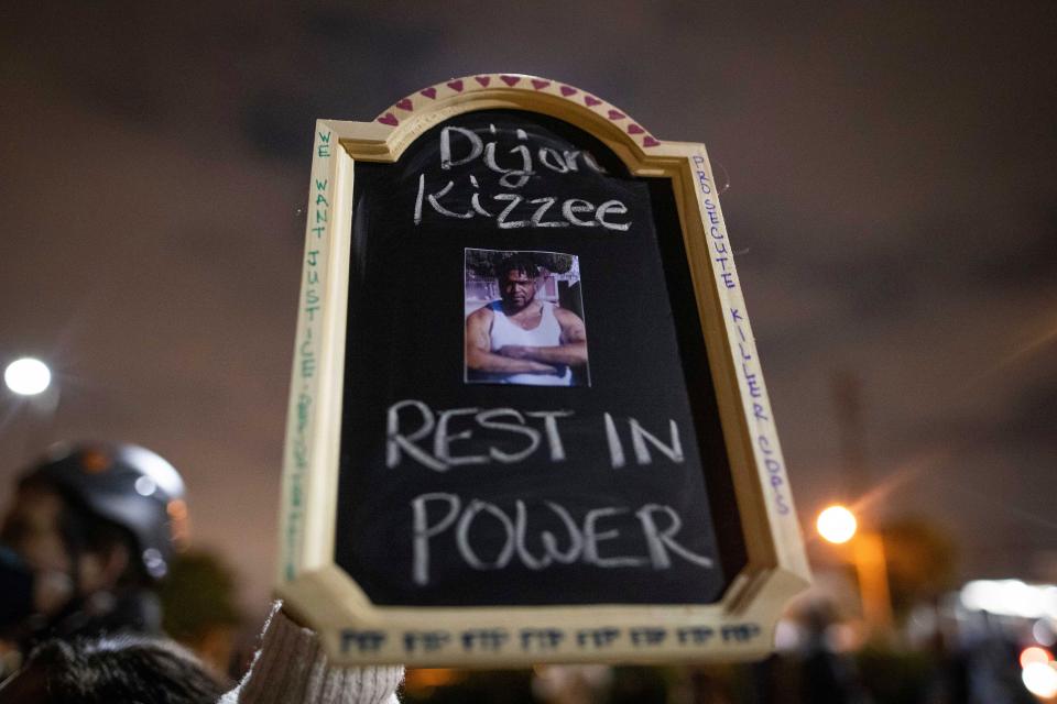 A protester holds a picture of Dijon Kizzee, who died after being shot by Los Angeles sheriff's deputies on Aug. 31.