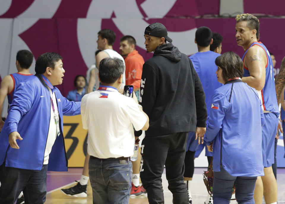 Filipino-American NBA player Jordan Clarkson, center, walks after the game Kazakhstan at the men's basketball match at the 18th Asian Games in Jakarta, Indonesia on Thursday, Aug. 16, 2018. Clarkson will play with the Philippine team on the next games. (AP Photo/Aaron Favila)