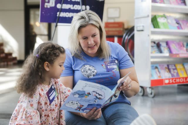 <p>Veterans United Home Loans</p> A Veterans United team member volunteers at a Scholastic book fair in Columbia, Mo