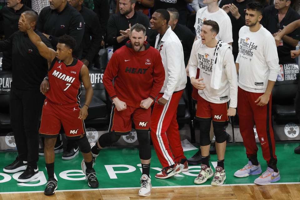 Miami Heat guard Kyle Lowry (7), forward Kevin Love, second from left, and other teammates react during the second half of Game 2 of the NBA basketball playoffs Eastern Conference finals against the Boston Celtics in Boston, Friday, May 19, 2023. (AP Photo/Michael Dwyer)