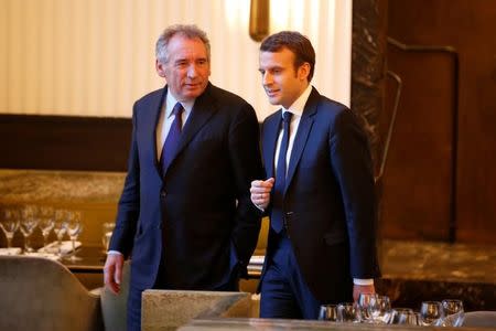 Emmanuel Macron (R), head of the political movement En Marche !, or Onwards !, candidate for the 2017 presidential election, and Francois Bayrou, French centrist politician and the leader of the Democratic Movement (MoDem), arrive for a news conference after sealing seal their alliance for the presidential campaign, in Paris, France, February 23, 2017. REUTERS/Charles Platiau