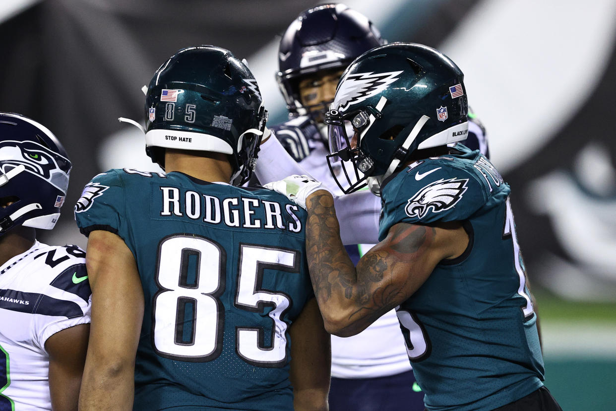Richard Rodgers of the Philadelphia Eagles is congratulated by teammate Travis Fulgham after catching a Hail Mary pass in the final seconds on Monday night. (Photo by Elsa/Getty Images)