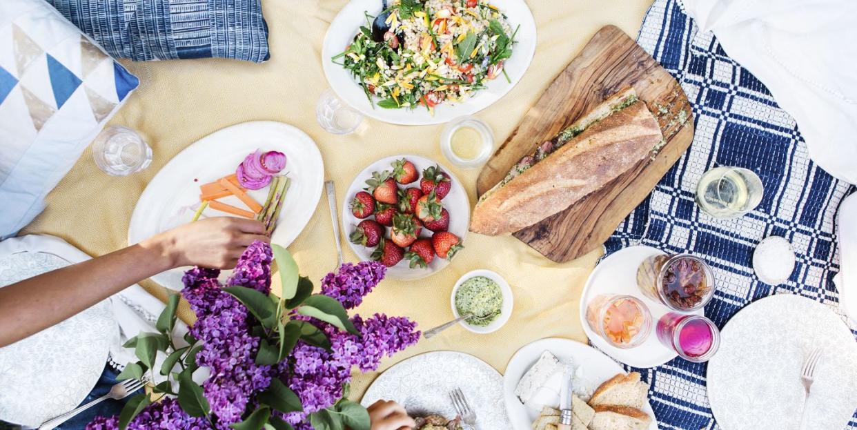 june holidays backyard picnic spread on a yellow blanket for picnic day