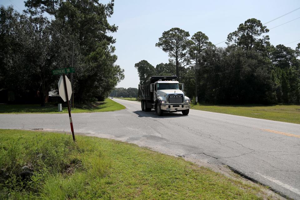 A dump truck drives along Goshen Road past Stephens Drive in Effingham County.